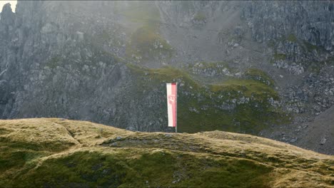 a flag in österreich is on a little hill