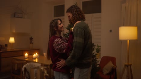 couple dancing around christmas tree