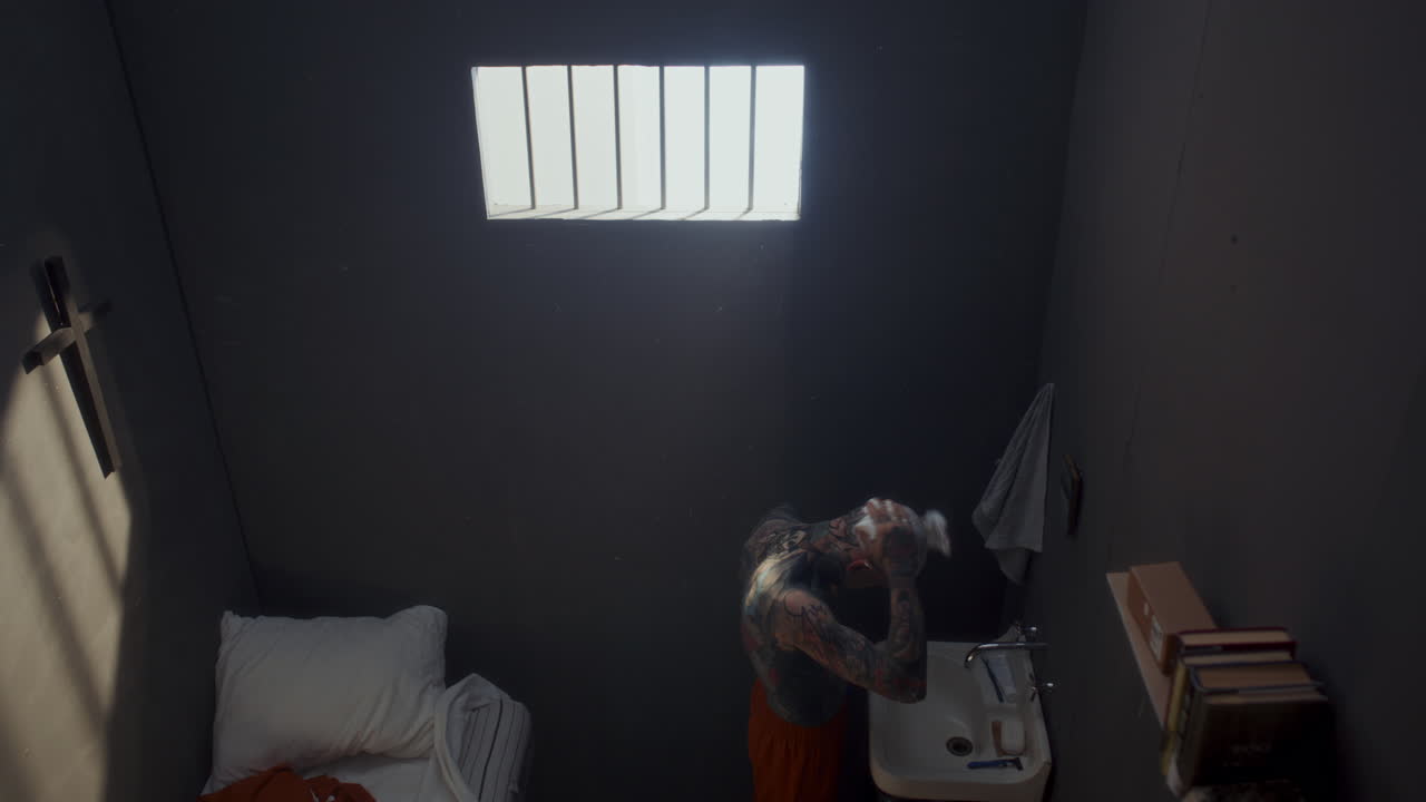 High Angle View of Tattooed Man Applying Shaving Foam to His Head in Prison