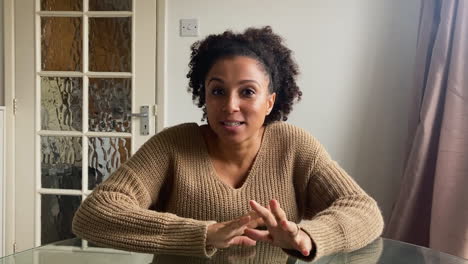 young woman on video call telling story to her friends directly into camera