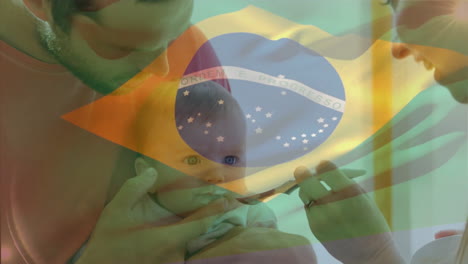 animación de la bandera de brasil sobre la madre caucásica que alimenta al bebé