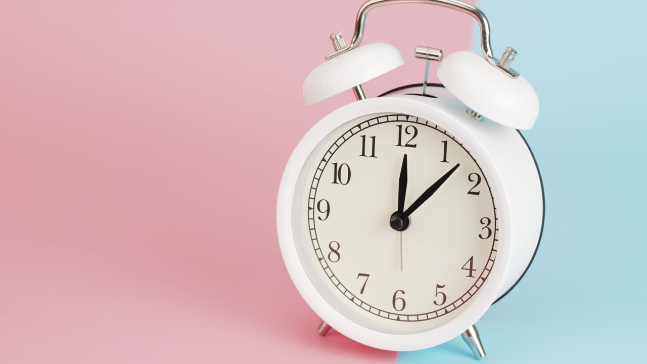 타임 스 화이트 알람 시계는 오후 1시 10분을 나타니다.