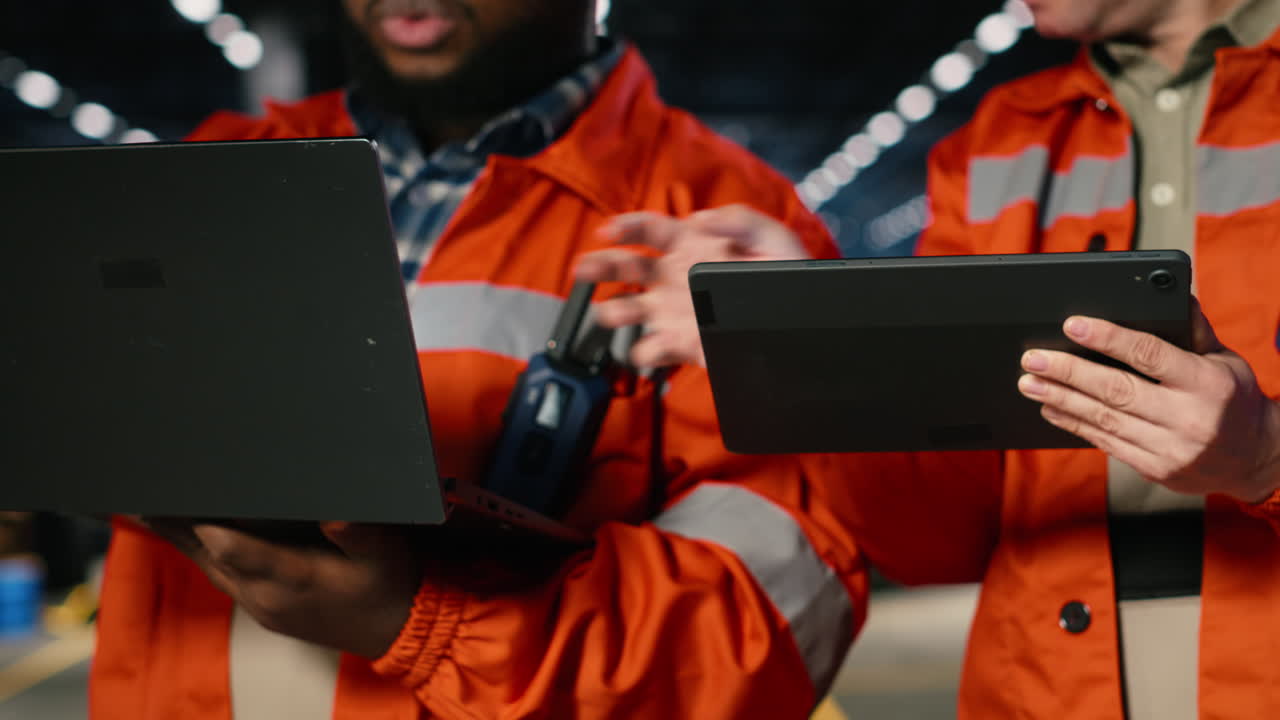 Engineers team coordinates strong labor in industry plant with gadgets