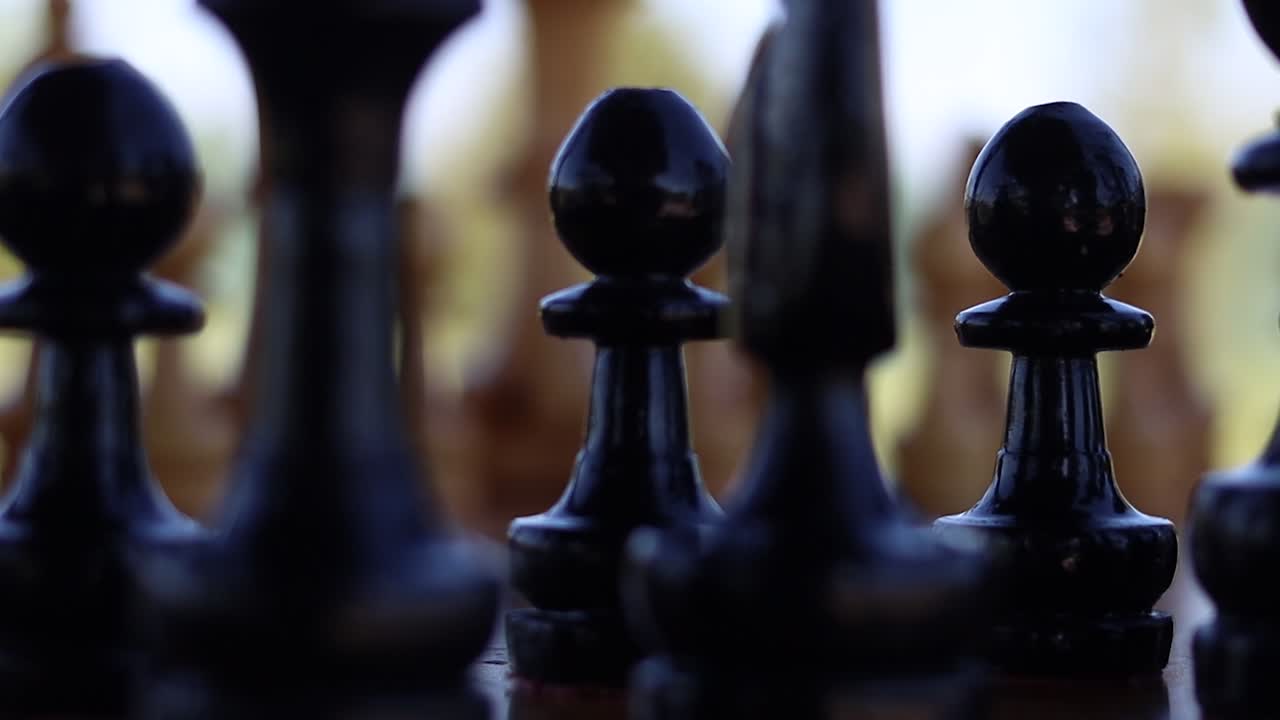 Black pawns in focus on a set game of chess