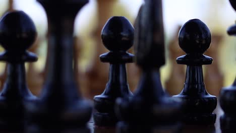 black pawns in focus on a set game of chess