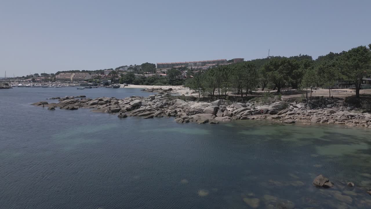 Raw Drone Footage of Coastal Village With Marina and Forest Ending in Beach