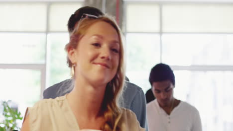 barista preparing coffee drink for diverse people in queue of cafe