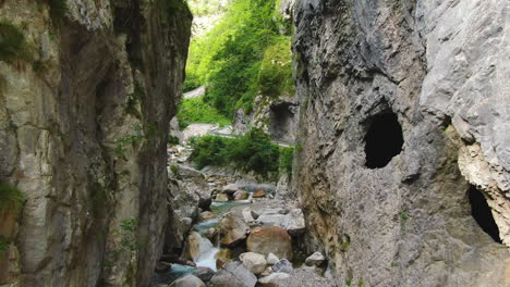 shallow river flows between the rocks by the traffic road