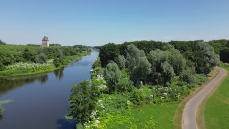 Aerial-drone-shot-above-a-nature-park,-water-canal,-abandoned-kastel-of-Almere-city,-province-Flevoland,-Netherlands