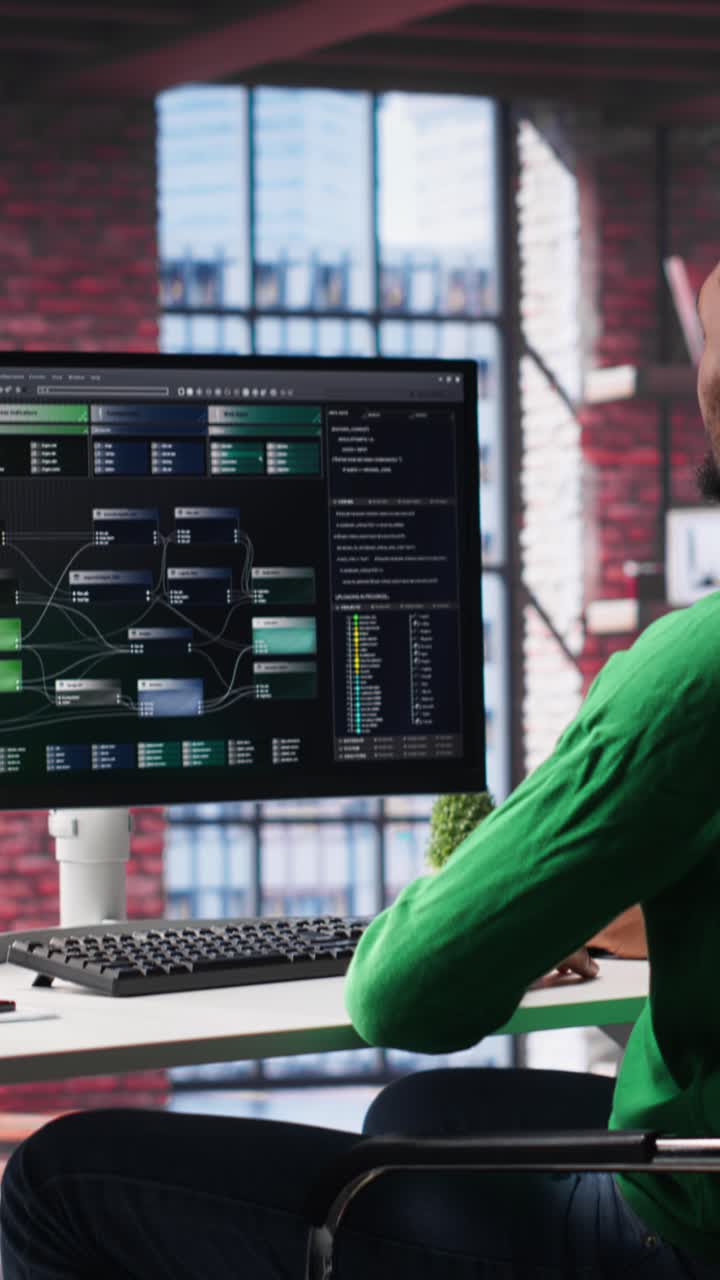 Vertical Video African american engineer at home working on visual coding on terminal window