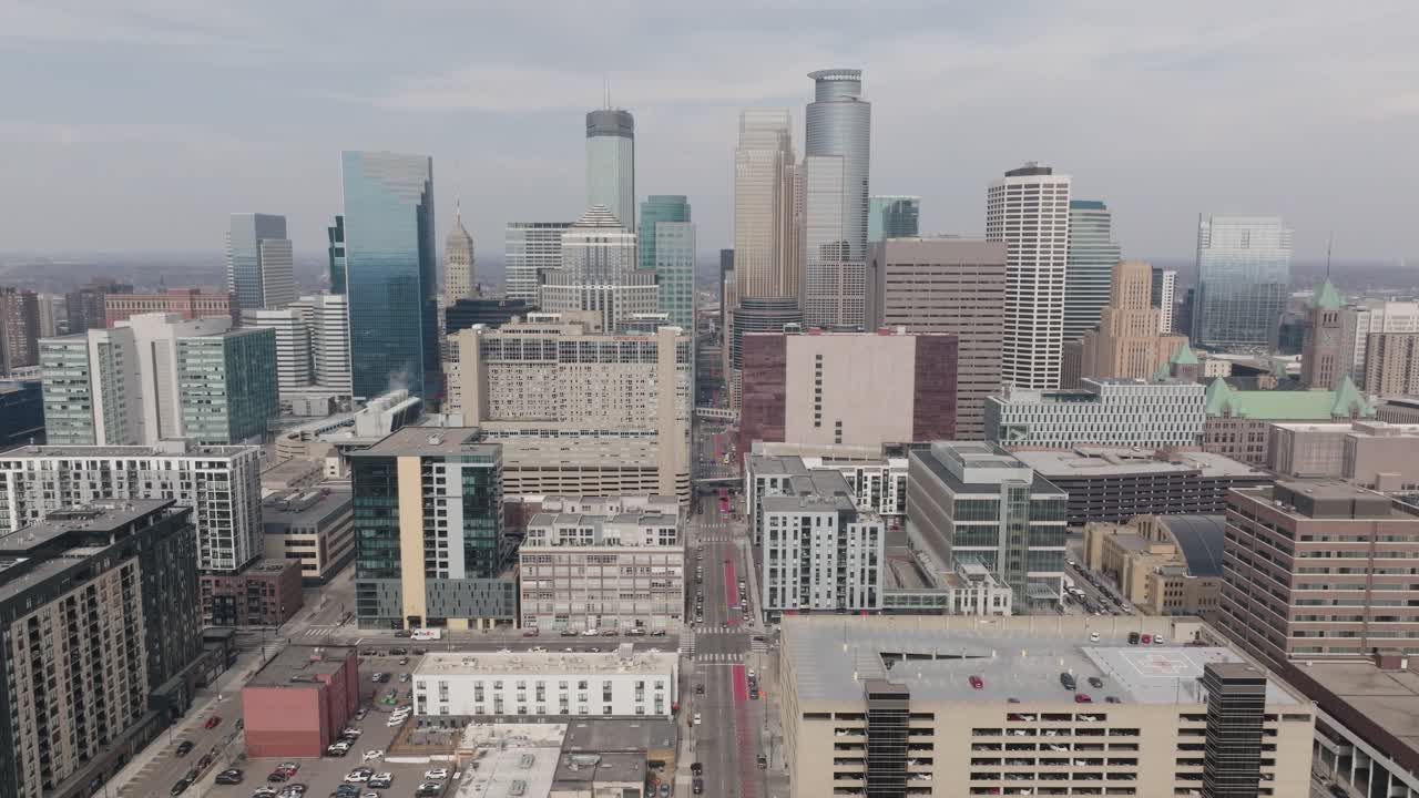 Drone hovers over downtown Minneapolis capturing detailed skyline architecture.