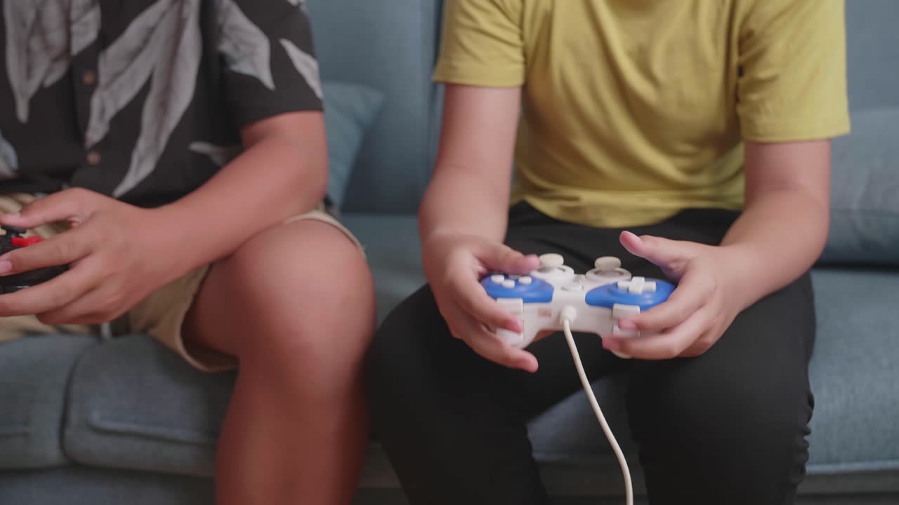 Close Up Children'S Hands Holding Joystick Game Play Video Game At Home