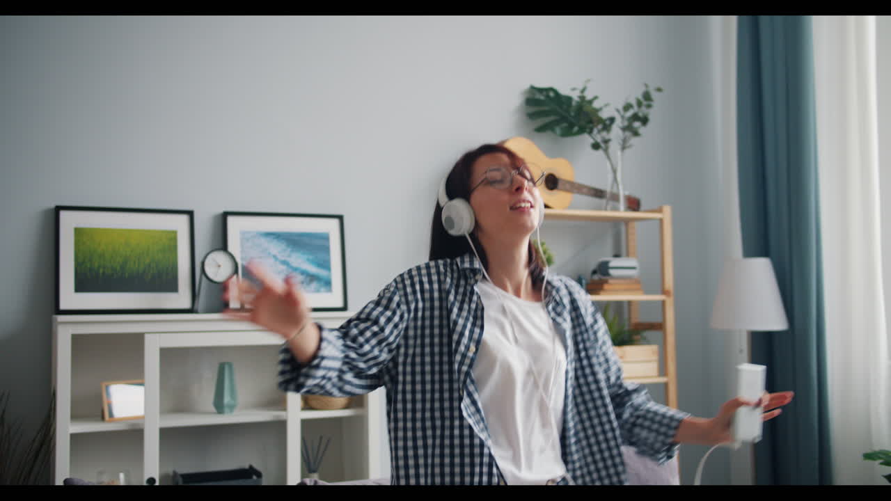 Woman Dancing and Listening to Music at Home