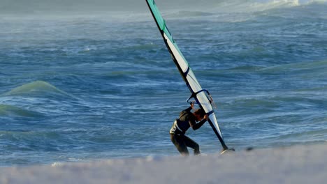 male surfer windsurfing in the beach 4k