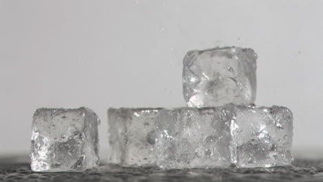 raindrops in super slow motion falling on ice cubes