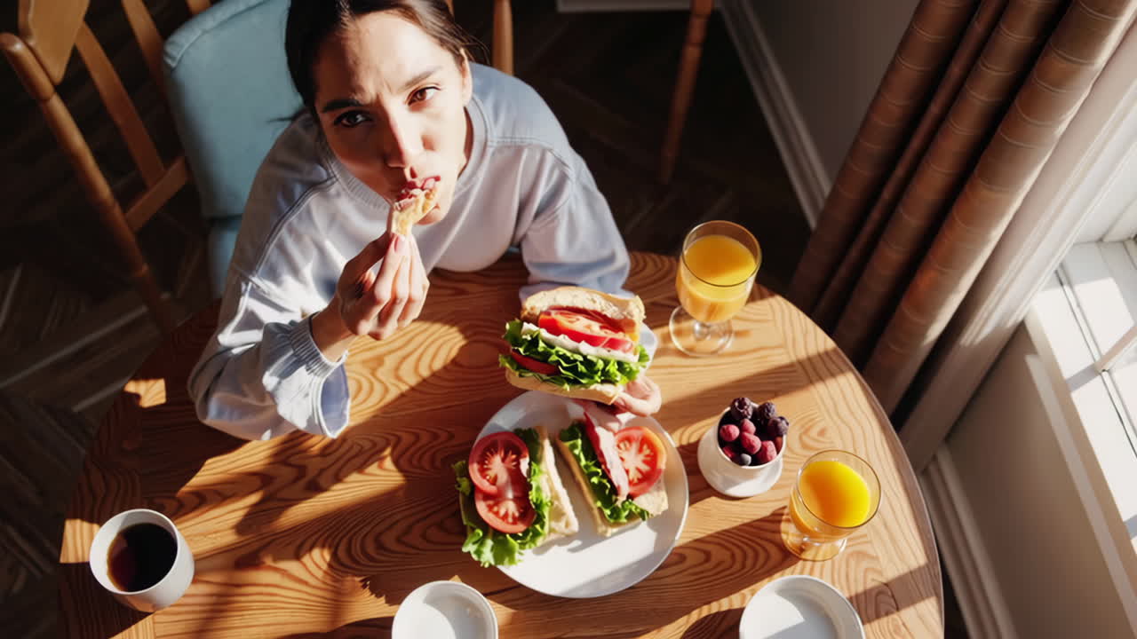 Person Enjoying a Meal at a Sunny Table