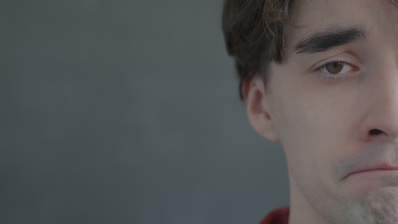 Close-up of a young man with a sad expression