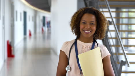 Portrait-Of-Female-Doctor-Walking-Towards-Camera-And-Smiling