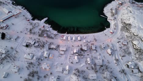 Stunning-high-view-of-Norwegian-fjords-and-Ersfjordvegen-village-with-snowy-mountains-and-blue-sea