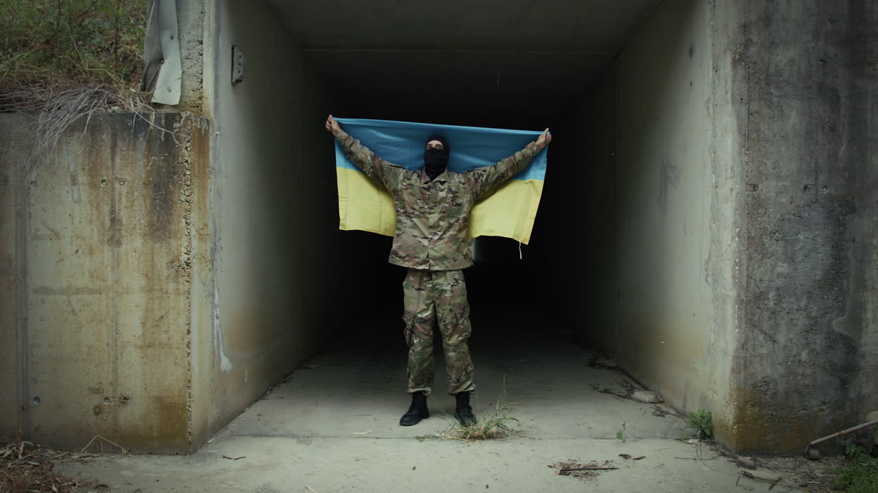 Ukrainian Soldier Waving Flag From Inside Bomb Defensive Bunker