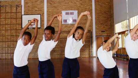 school kids exercising in basketball court