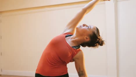 Woman-doing-stretching-exercise-on-exercise-mat