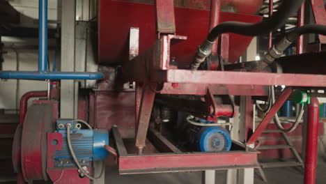 Air-pumps-installed-on-red-metal-rack-in-mechanical-room