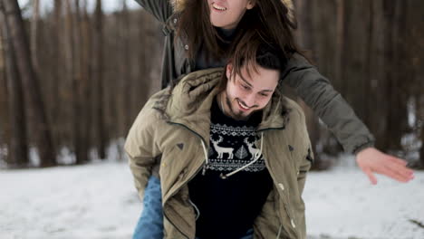 caucasian couple hiking on a snowed forest.