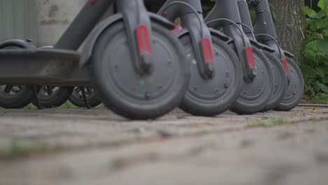 row of gray electric scooters-1