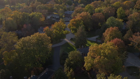 flyover beautiful fall trees and nice houses at sunset in ladue missouri