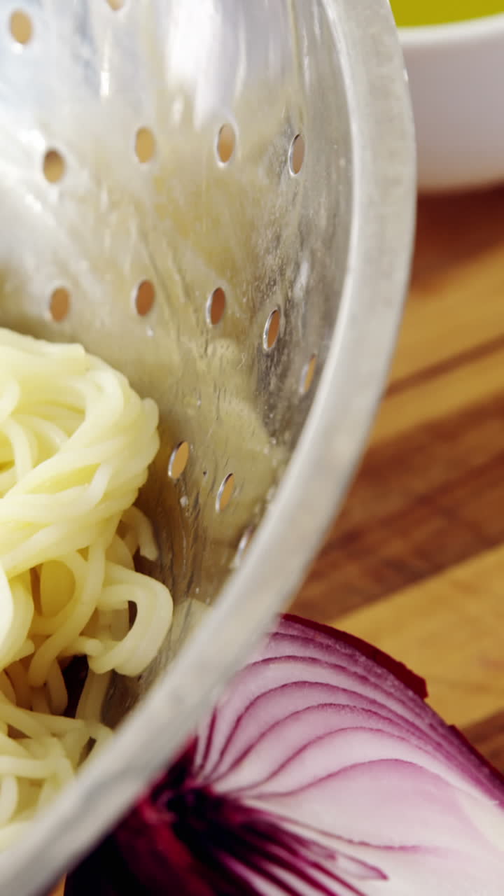 Close-up of boiled pasta in colander
