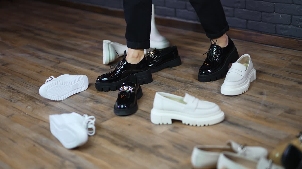 Walking among the demonstrated footwear. Woman model moves shoes on the way to walk in chosen black pair of shoes.