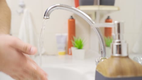 washing hands in water close-up. liquid soap.