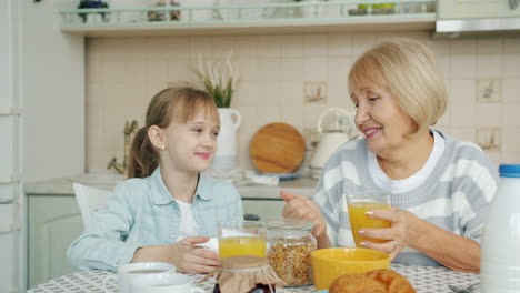 grandmother and granddaughter having breakfast