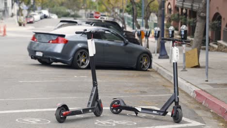 city scooters in designated parking spot on street