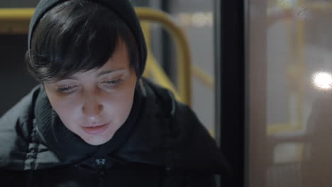 woman commuter with mobile in the bus