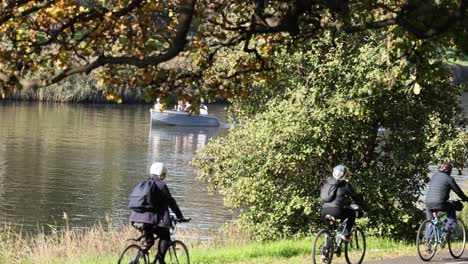 cyclists and boaters enjoying yarra river scenery