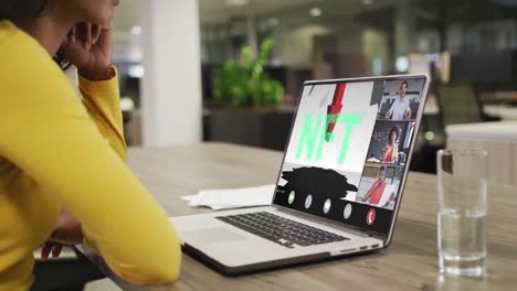 african american businesswoman using laptop for video call with diverse business colleagues