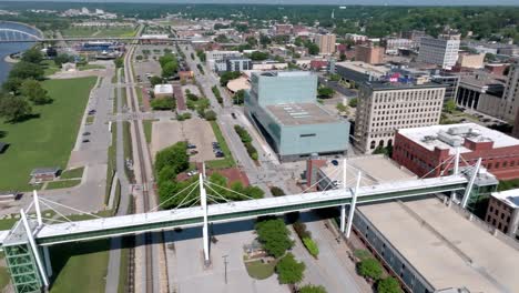 downtown davenport, iowa with drone video moving left to right from the mississippi river to the skyline