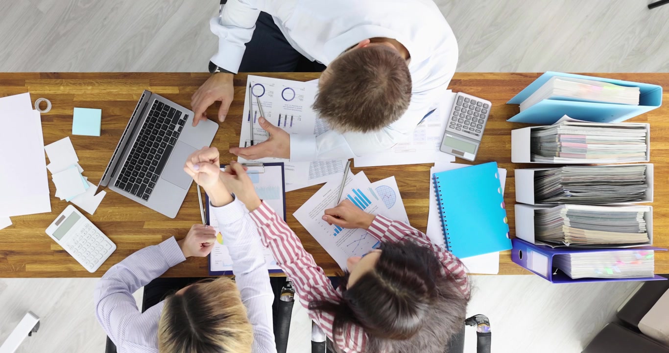 Group of businesspeople seeing information in laptop and rejoicing top view 4k movie slow motion