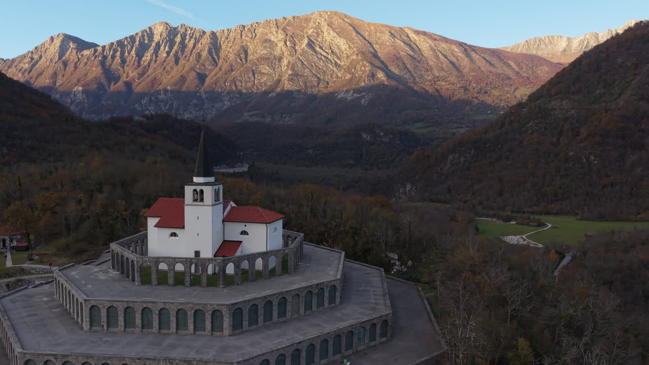 Aerial rotating view of the St Anton Church and Kobarid Ossuary, a World War I memorial in Slovenia