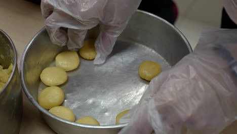 arranging biscuit dough