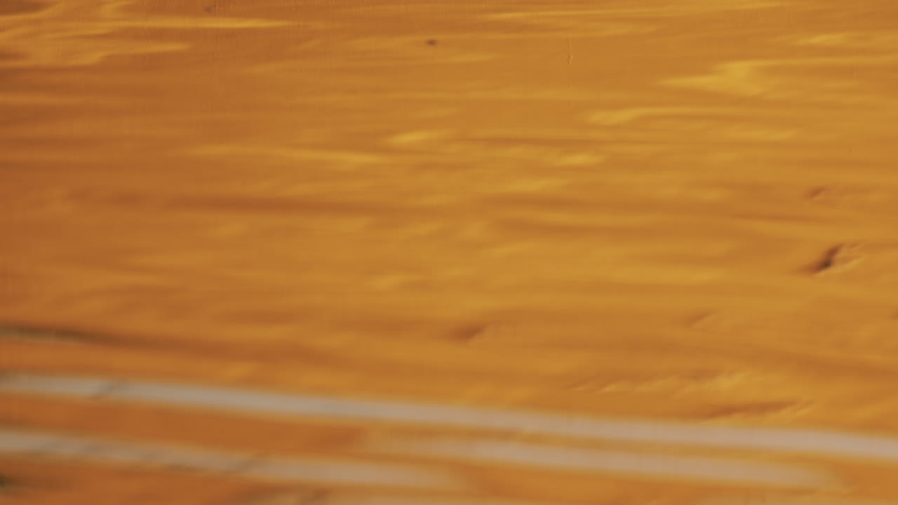 Abstract close up of a yellow boat reflection on the water