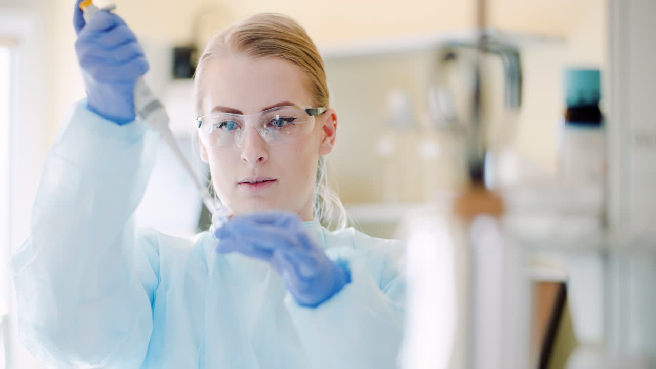 Female Scientist With A Pipette Analyzes A Liquid At Laboratory 1