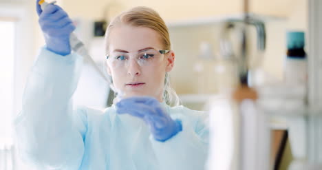 female scientist with a pipette analyzes a liquid at laboratory 1