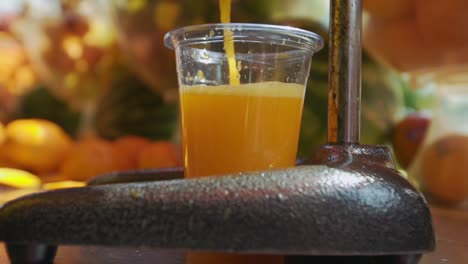 shot of orange juice squeezed in orange juicer