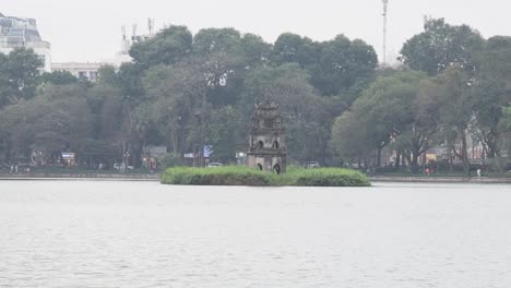 tranquil water, ancient ruins, lush greenery, urban backdrop