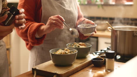 a couple cooking dinner together in their kitchen