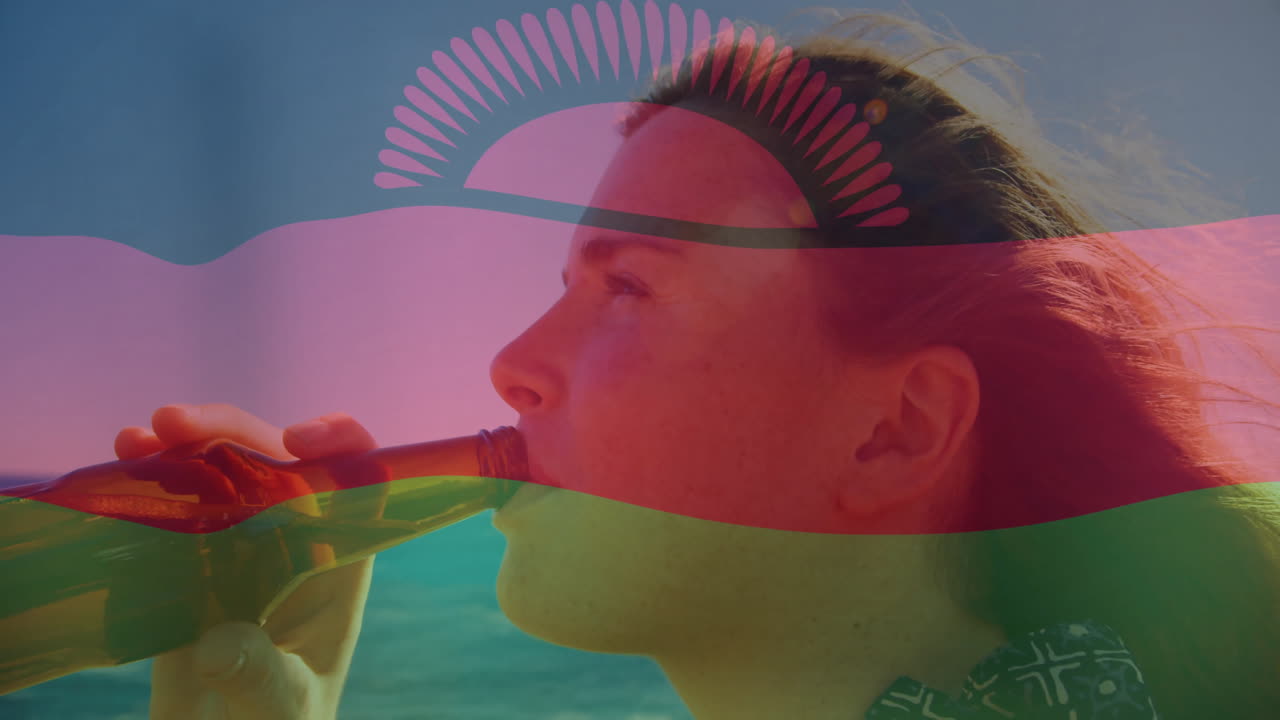 Drinking from bottle with Malawi flag overlay, person standing by ocean