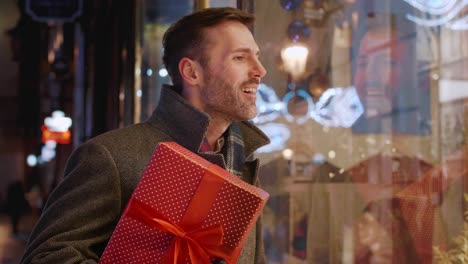 man with a big gift entering the flower shop